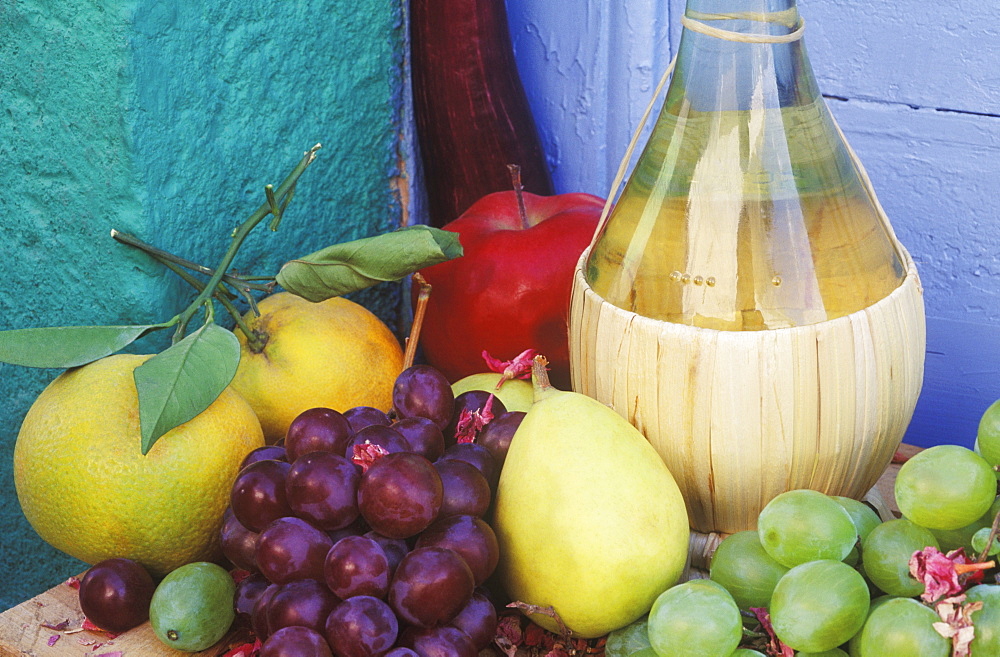 Close-up of a bottle with fruit on the table