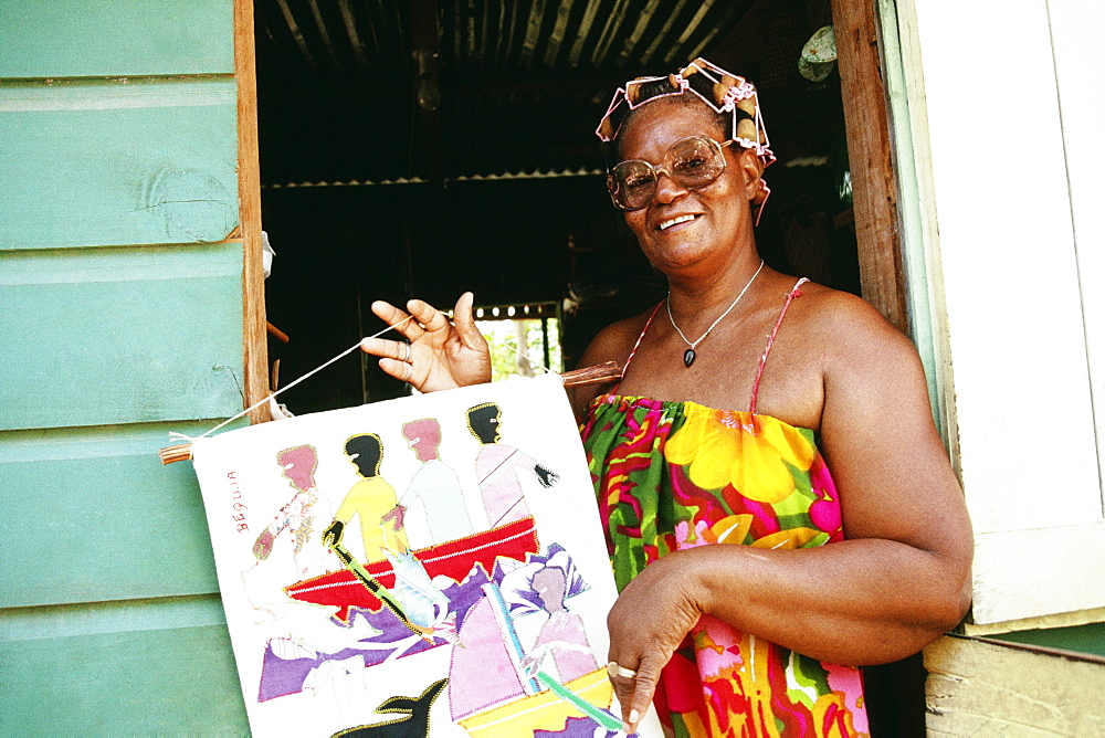 An African-American woman poses with a painting