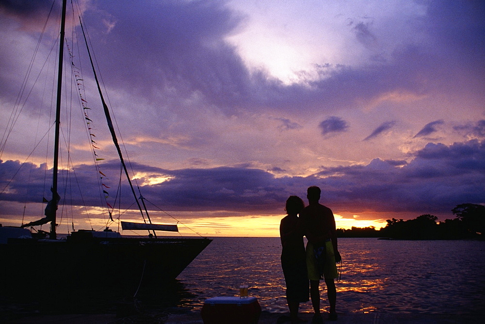 Silhouette of a couple on Negril Beach at sunset, Jamaica