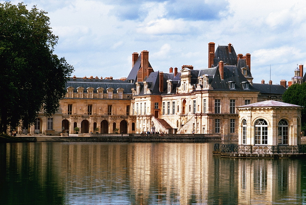 View to Fountainbleau chateau on a riverbank, France