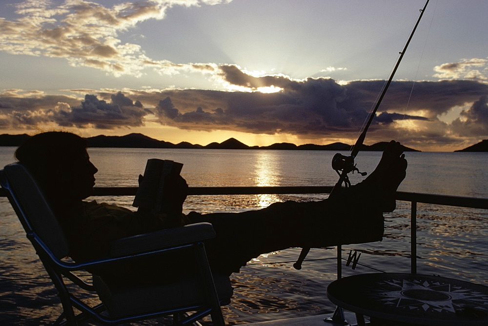 Silhouette of a person reading a book, St. John, Virgin Isles