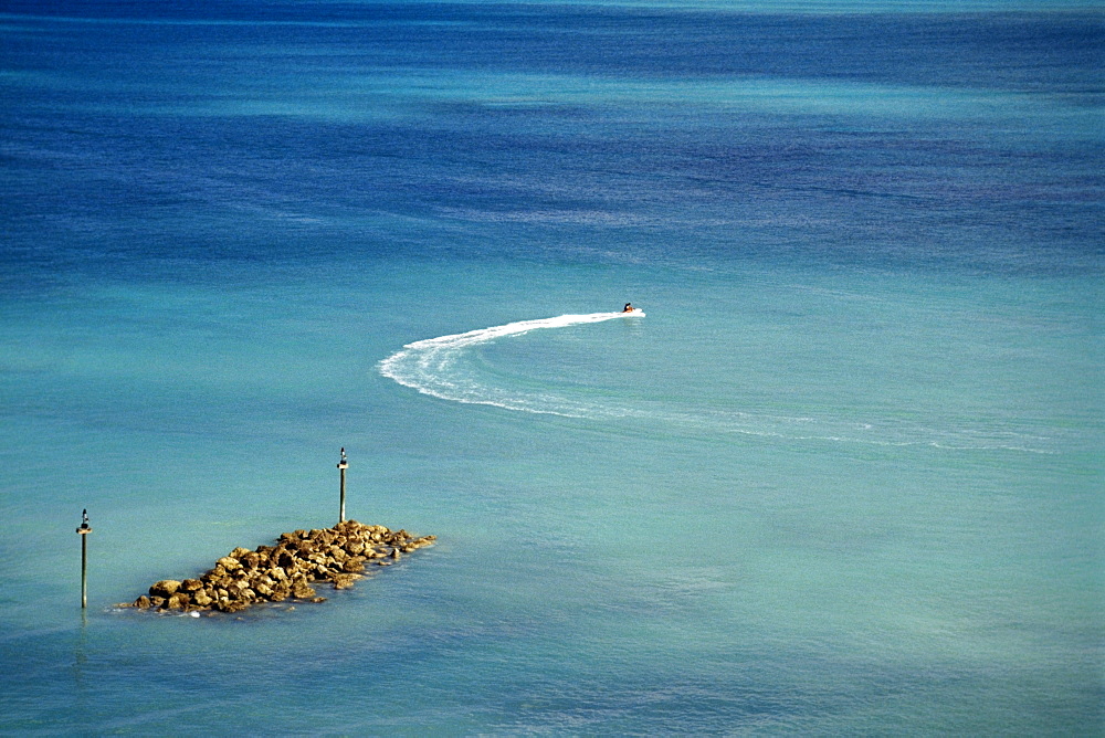 High angle view of two people riding a sea scooter, Nassau, Bahamas