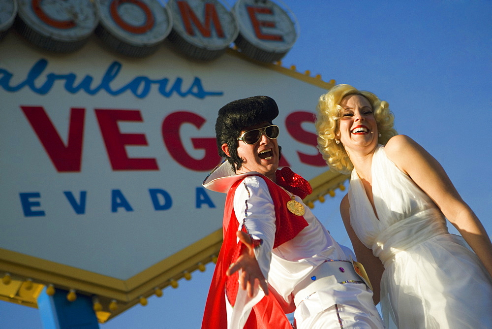 Mid adult man and a mid adult woman dressed in costumes, Las Vegas, Nevada, USA