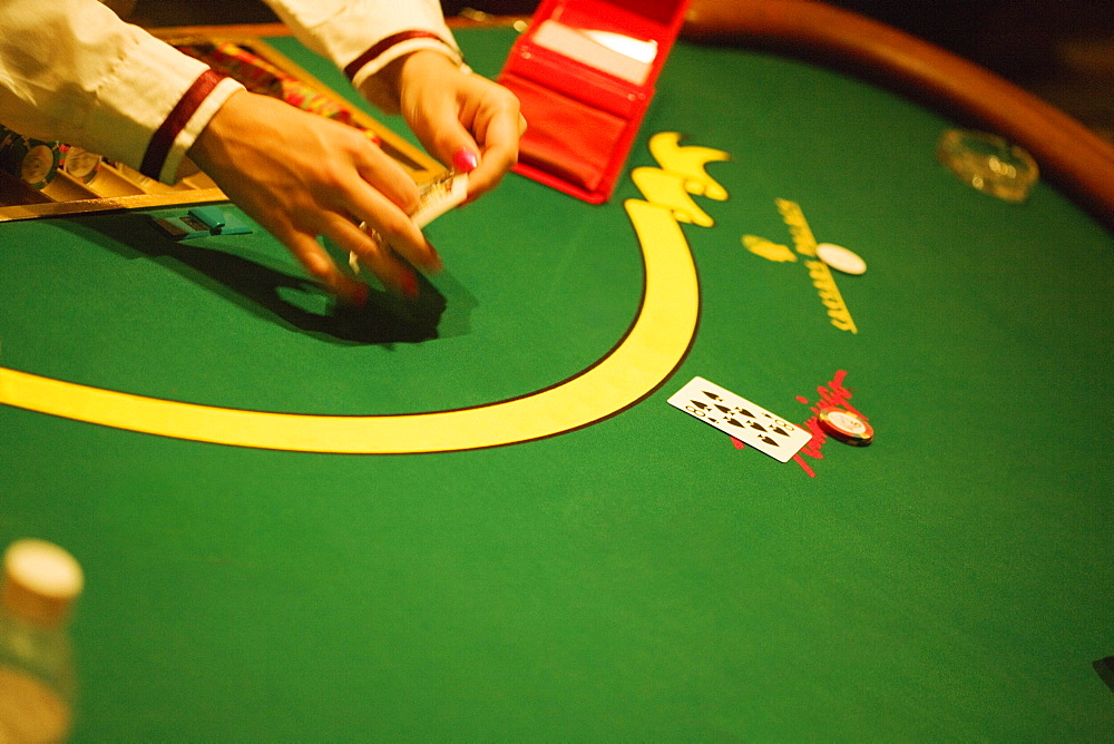 High angle view of a person's hand holding playing cards, Las Vegas, Nevada, USA