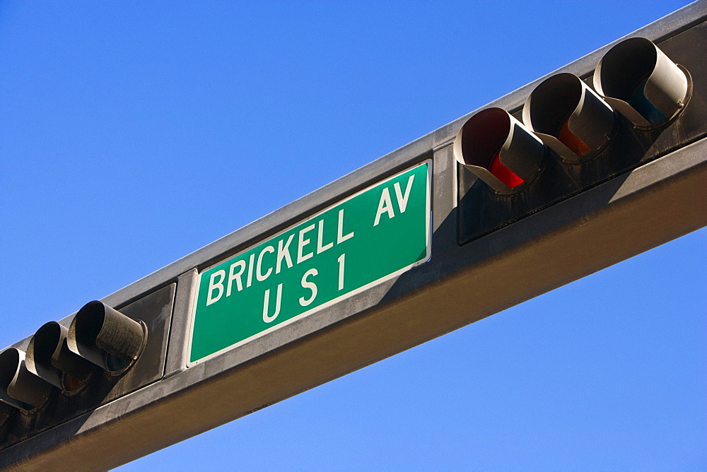 Low angle view of traffic lights with an information sign, Miami, Florida, USA