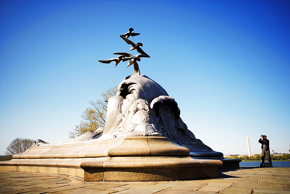 Tourist taking a photograph of a sculpture, Navy and Marine Memorial, Virginia, USA