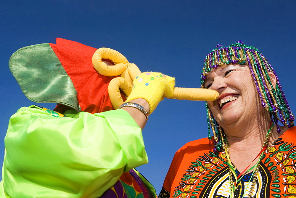 Low angle view of a senior woman wearing beaded headdress and looking at an another woman