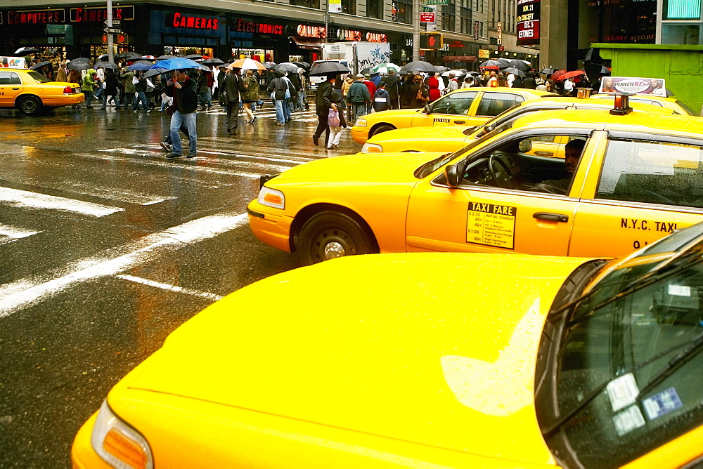 Yellow taxi waiting at the zebra crossing