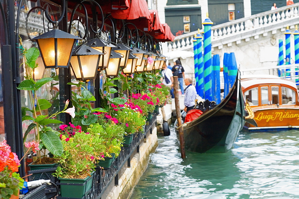 Side profile of a man standing on a gondola, Venice, Veneto, Italy