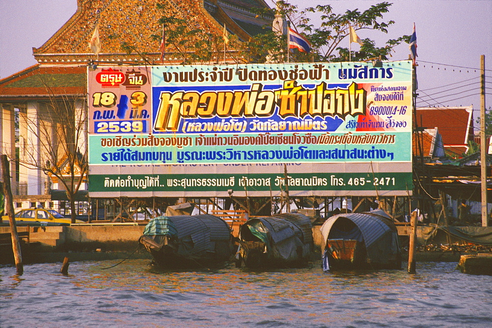 Billboard at a riverbank, Bangkok, Thailand