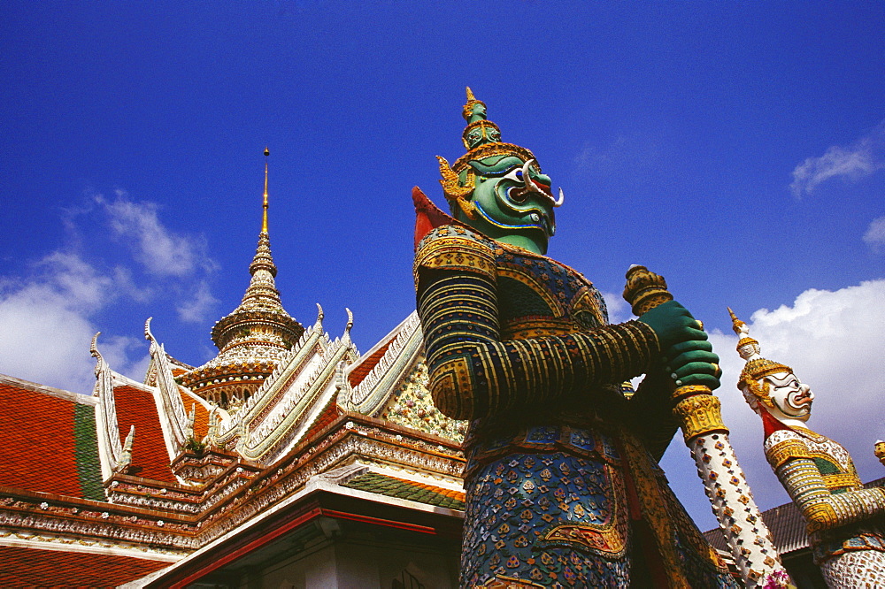 Low angle view of statues in front of a temple, Wat Arun, Bangkok, Thailand