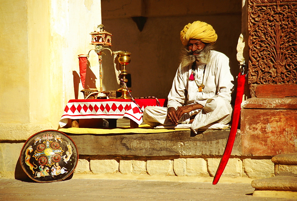 Senior man sitting at a veranda of a museum, Meherangarh Museum, Jodhpur, Rajasthan, India