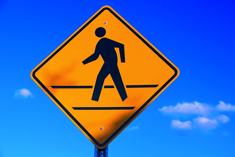 Low angle view of a pedestrian crossing sign