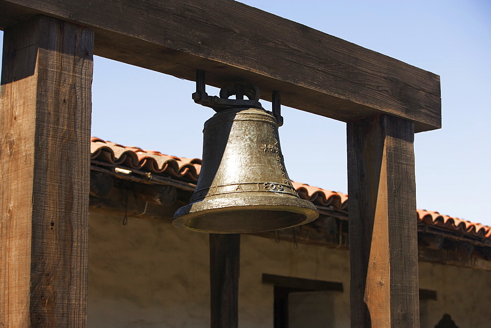 Close-up of a bell hanging in front of a house