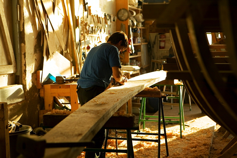 Rear view of a carpenter working in a workshop, Spain