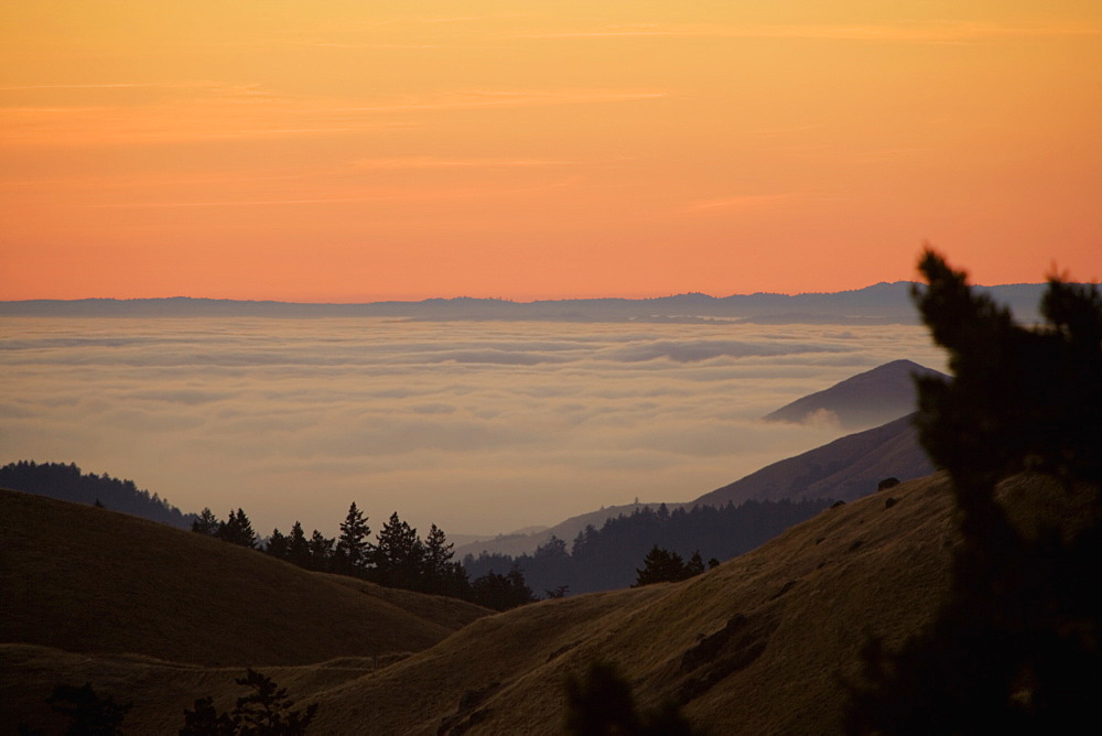 High angle view of clouds around a hill