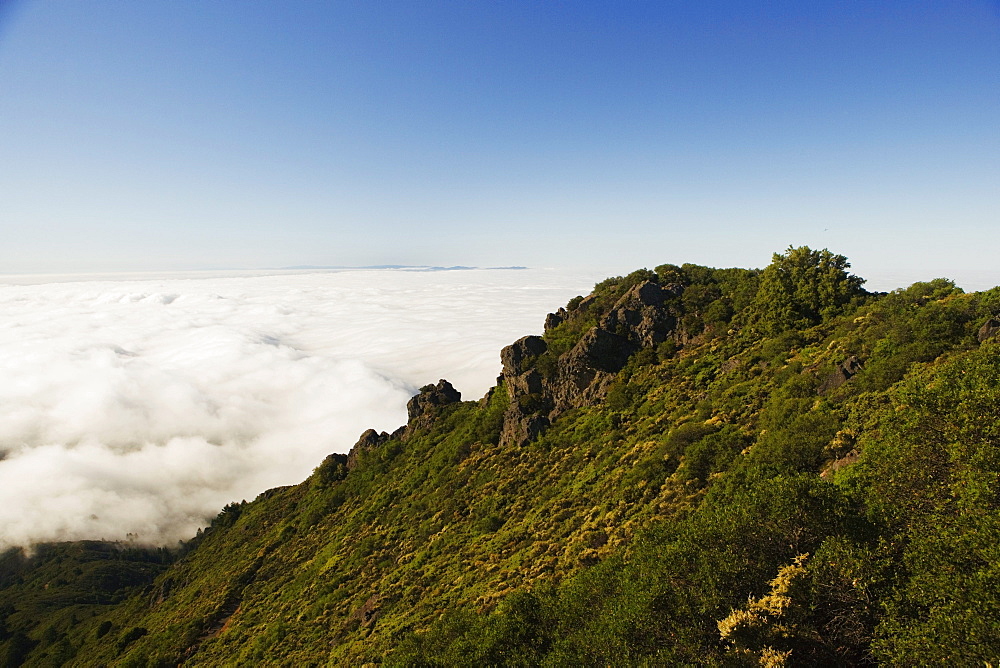 High angle view of clouds around a hill