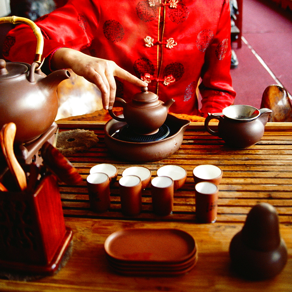 Mid section view of a woman preparing tea, Tongli, Jiangsu Province, China