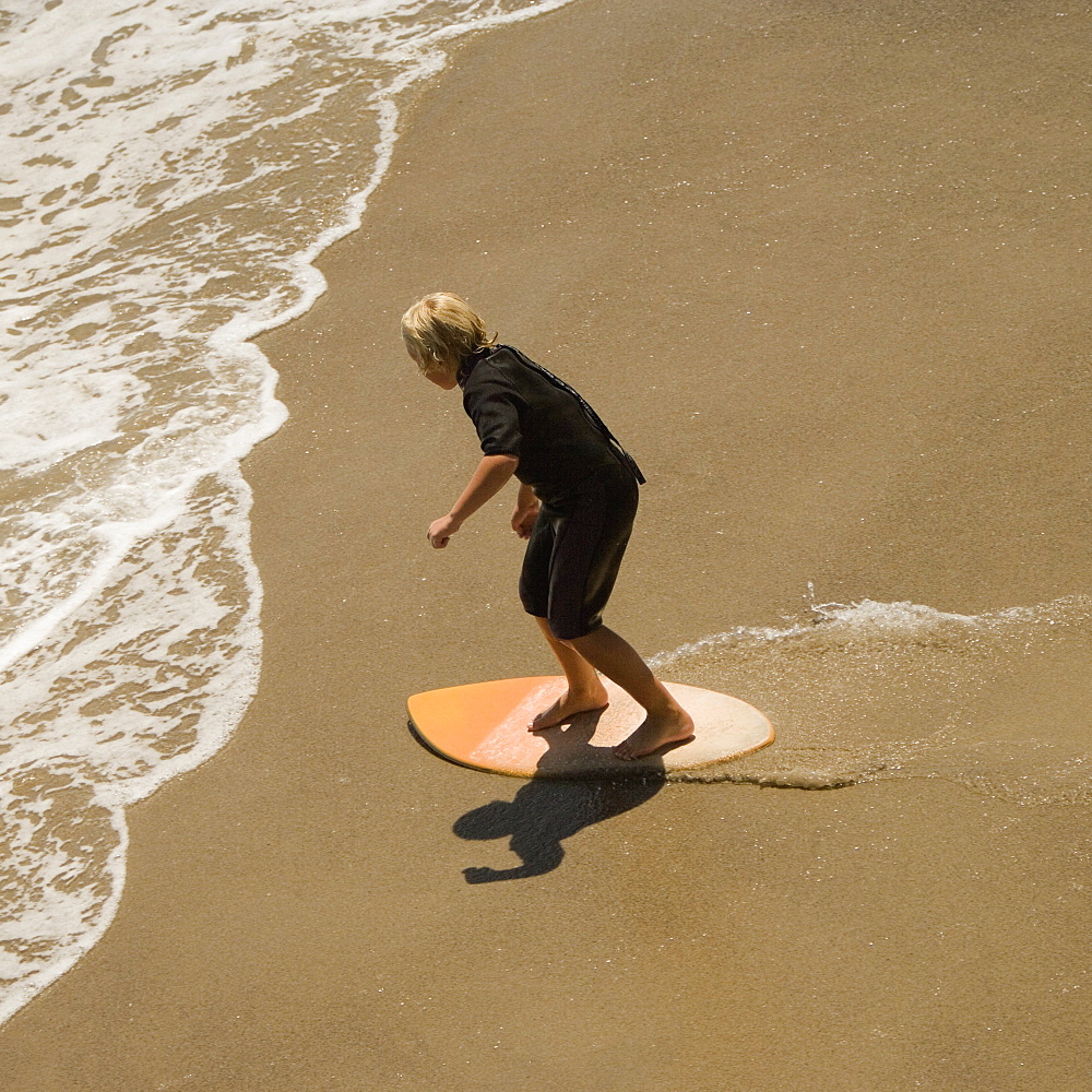 High angle view of two boogie boarder's on the beach