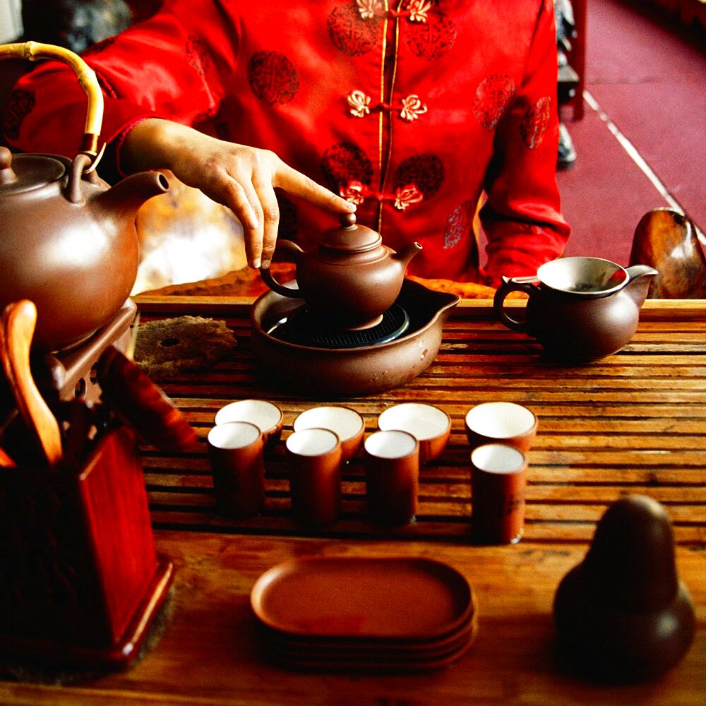 Mid section view of a woman preparing tea, Tongli, Jiangsu Province, China