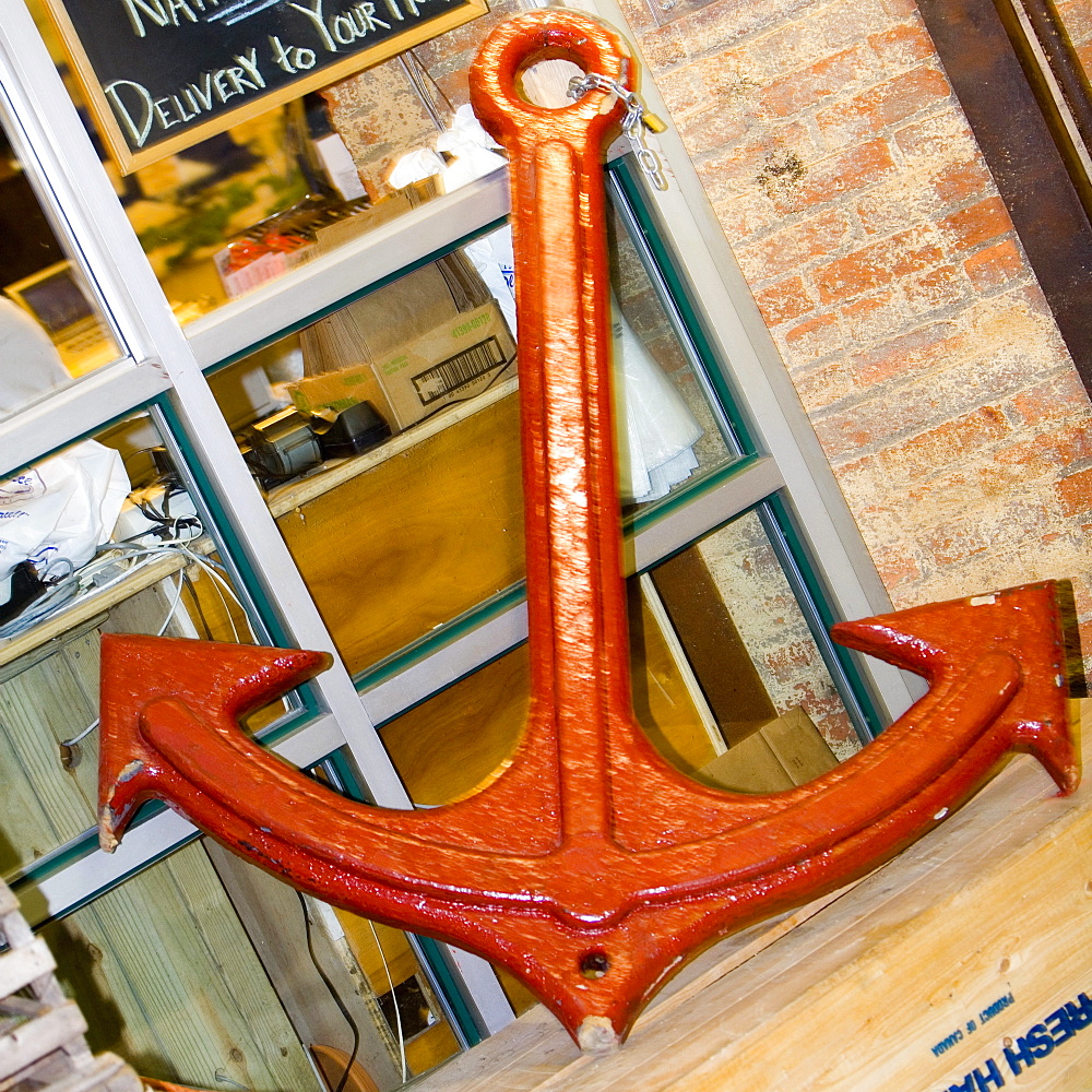 Close-up of an anchor leaning against a window