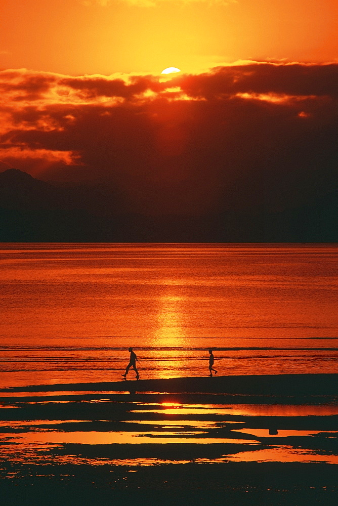 Silhouette of two people on the beach, Suva, Fiji
