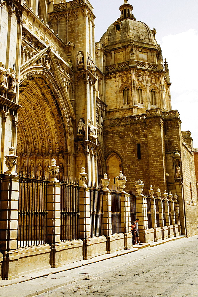 Tourists standing at the entrance of a cathedral, Cathedral Of Toledo, Toledo, Spain