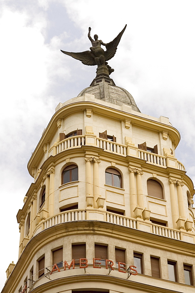 Low angle view of an angel statue on the top of a building, Madrid, Spain