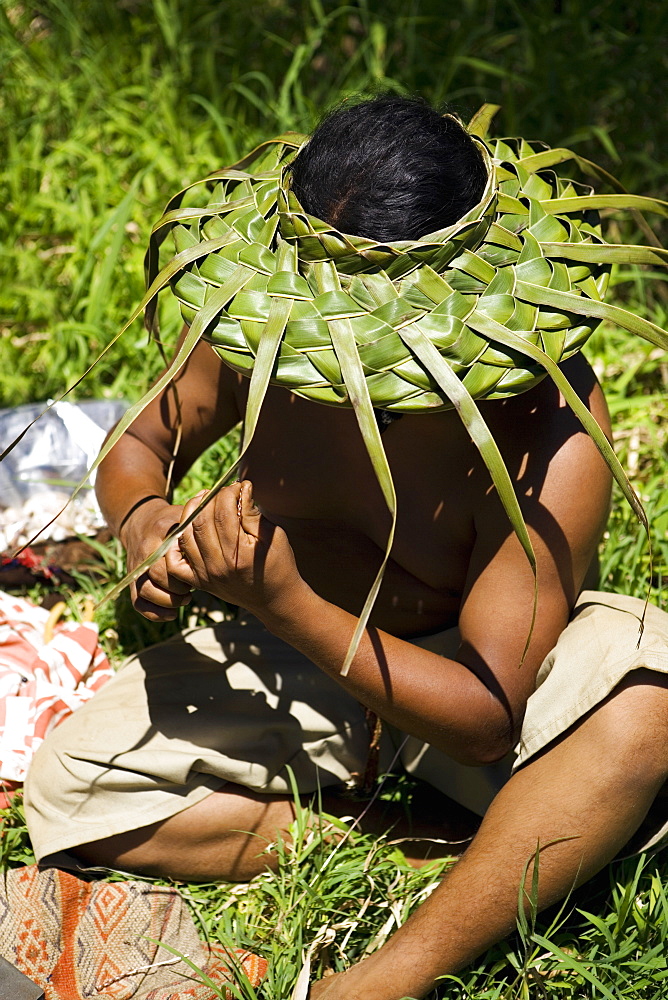 Close-up of a man sitting in a field, Maui, Hawaii Islands, USA