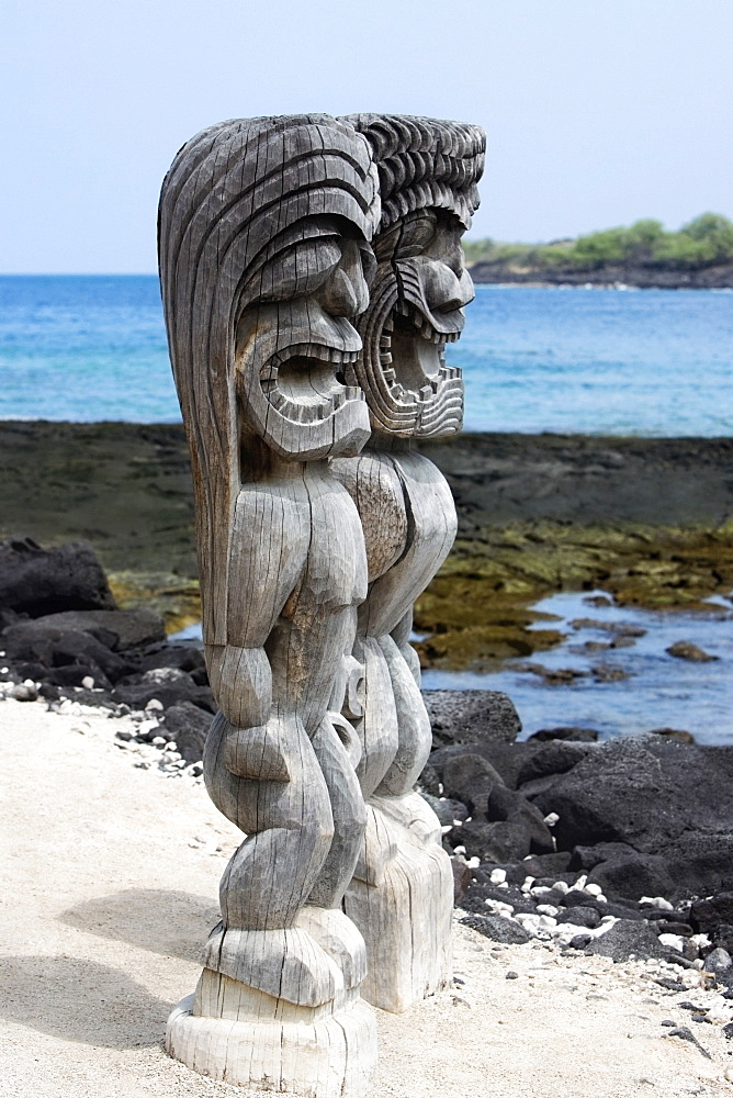 Two tiki torches on a sandy beach, Puuhonua O Honaunau National Historical Park, Kona Coast, Big Island, Hawaii Islands, USA