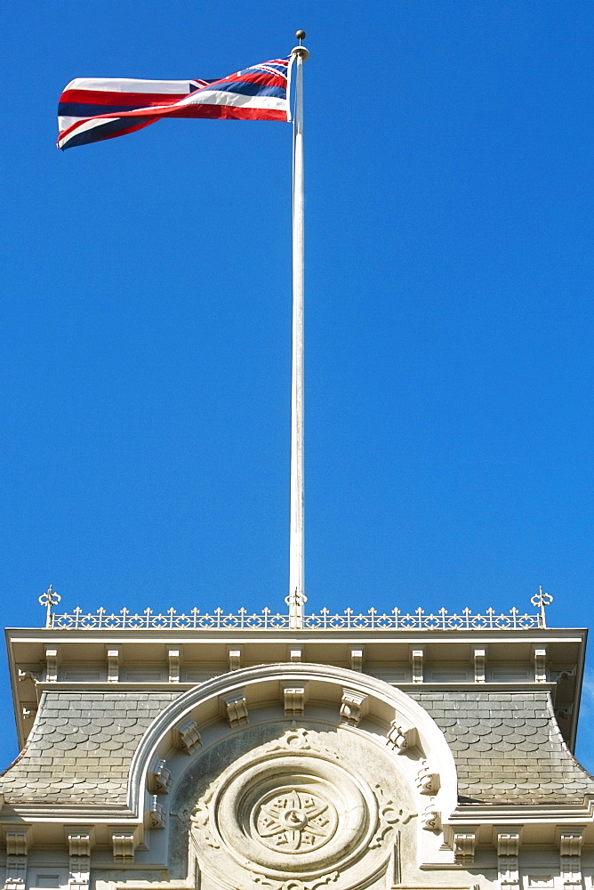 Low angle view of a US State Flag on a government building, State Capitol Building, Iolani Palace, Honolulu, Oahu, Hawaii Islands, USA