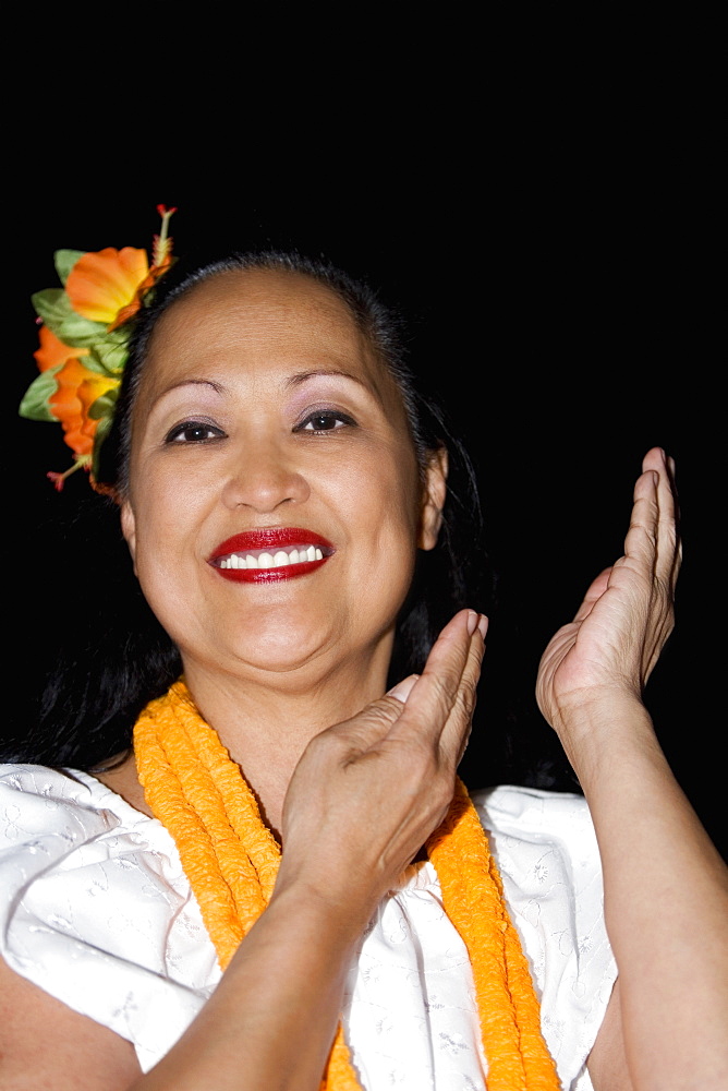 Portrait of a mature woman hula dancing and smiling