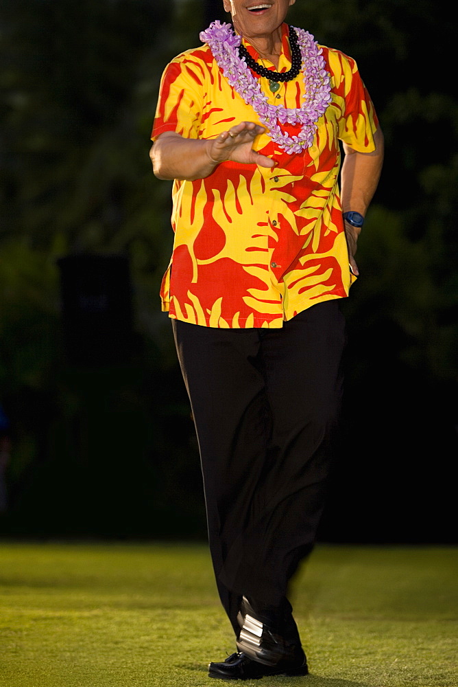 Man hula dancing in a lawn, Waikiki Beach, Honolulu, Oahu, Hawaii Islands, USA