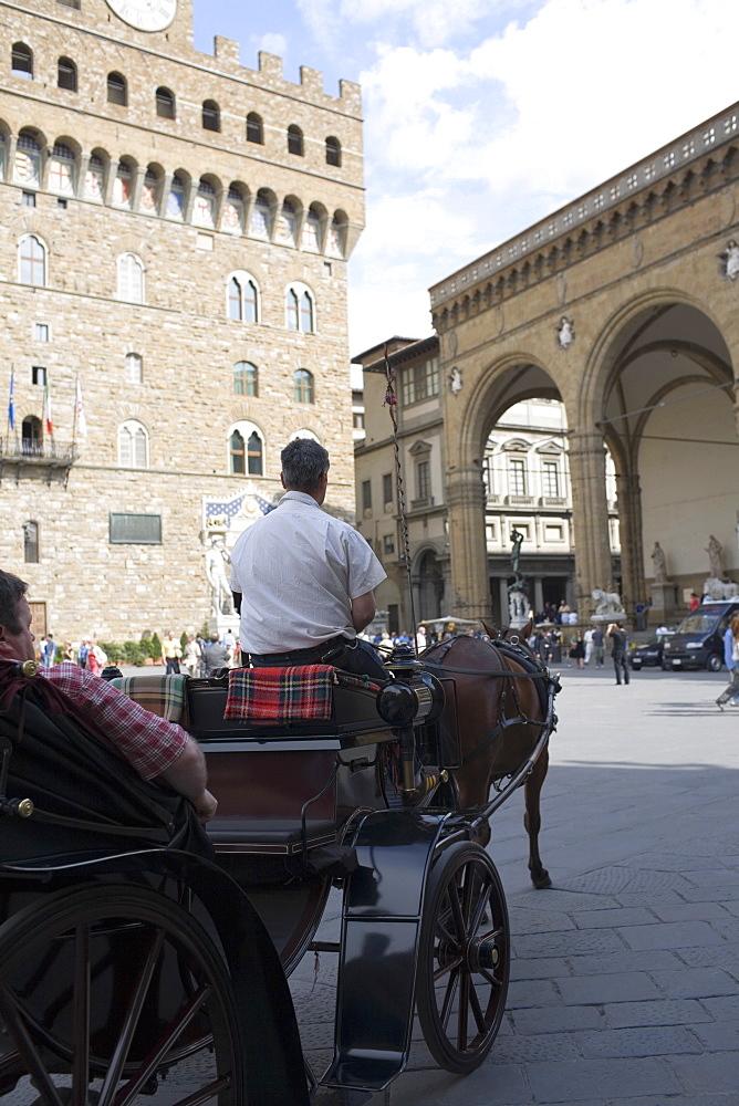 Rear view of a man driving a horsedrawn carriage, Portico of the Lansquenetes, Florence, Italy