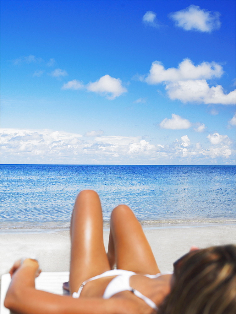 Woman lying on a lounge chair on the beach, Providencia, Providencia y Santa Catalina, San Andres y Providencia Department, Colombia