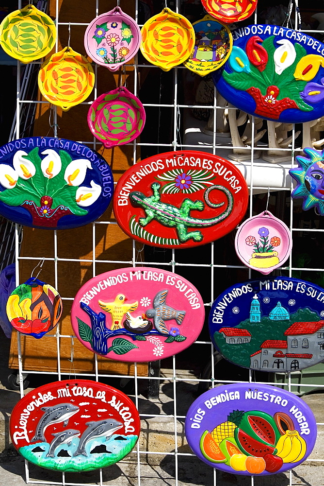 Ceramics hanging on a chain-linked fence, Cancun, Mexico