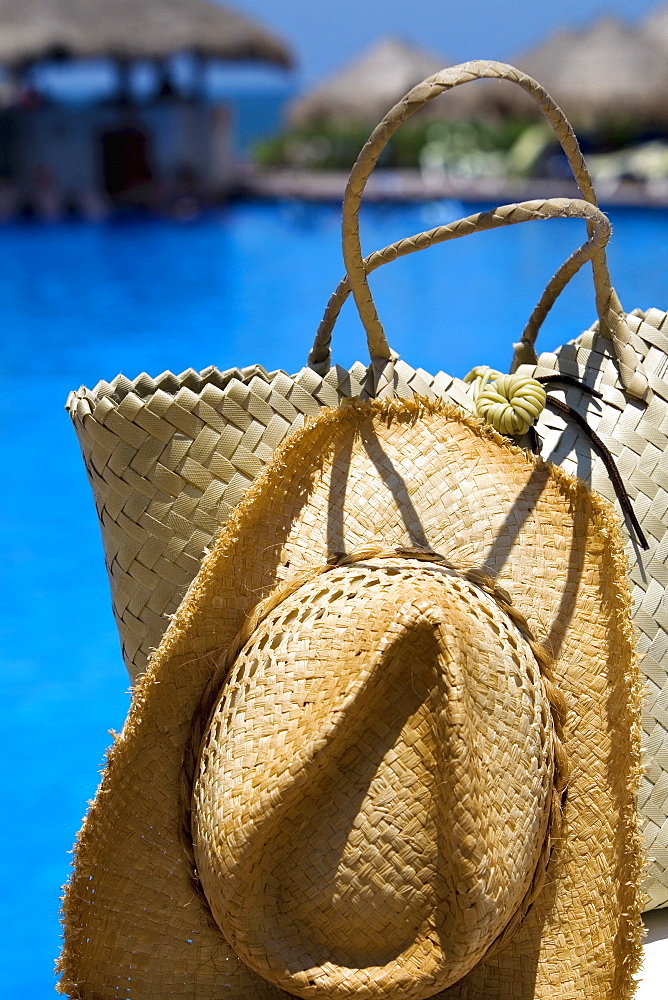 Close-up of a straw hat and a straw bag at the poolside, Cancun, Mexico