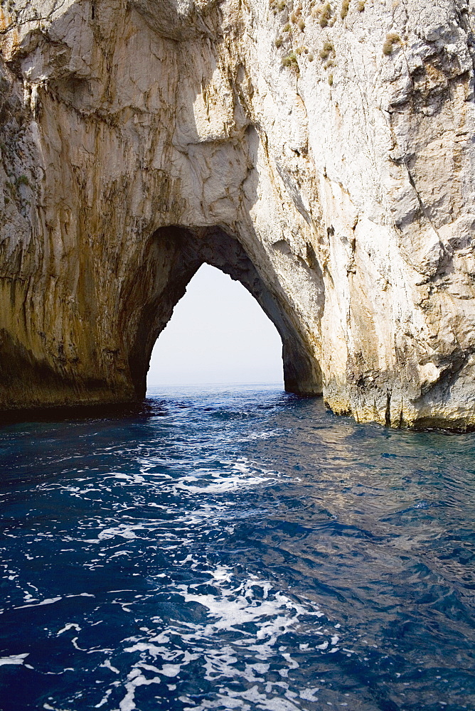 Natural arch in a rock formation, Faraglioni Rocks, Capri, Campania, Italy