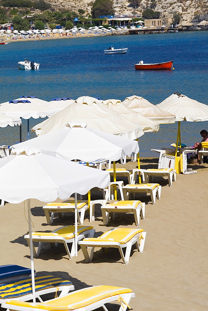 Lounge chairs and beach umbrellas on the beach, Lindos, Rhodes, Dodecanese Islands, Greece