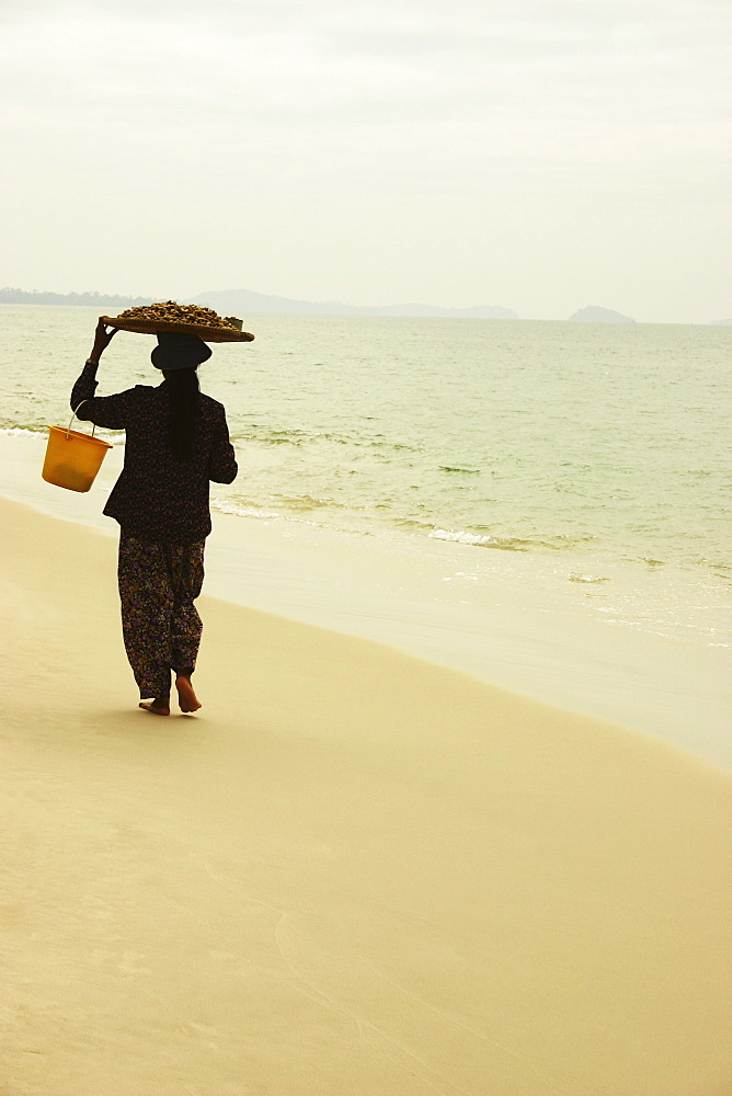 Rear view of a woman walking on the beach, Sihanoukville, Cambodia