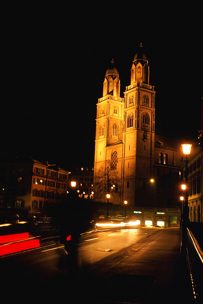 Low angle view of a church lit up at night, Grossmunster Cathedral, Zurich, Switzerland