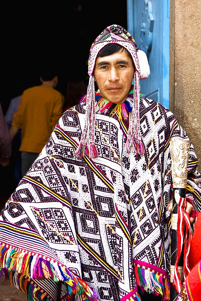 Portrait of a young man wearing a traditional clothing and holding a stick, Peru