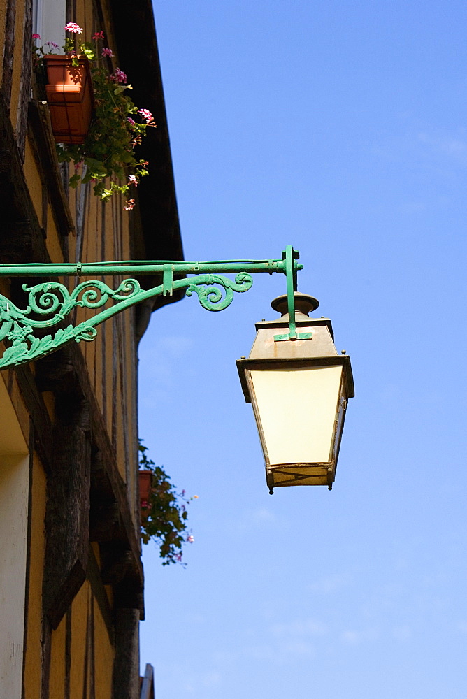 Low angle view of a lantern mounted on the wall, Le Mans, Sarthe, Pays-de-la-Loire, France