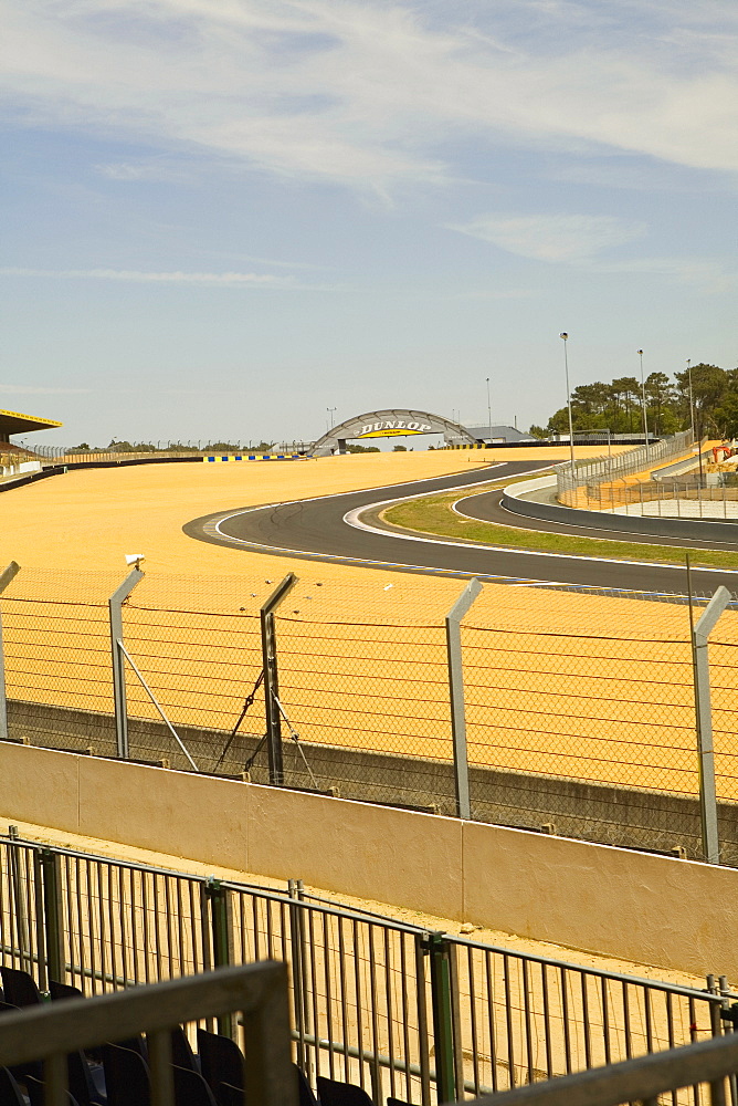 Chain-link fence along with motor racing tracks in a field, Le Mans, France