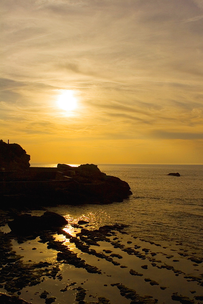 Silhouette of rocks in the sea at dusk, Biarritz, Basque Country, Pyrenees-Atlantiques, Aquitaine, France