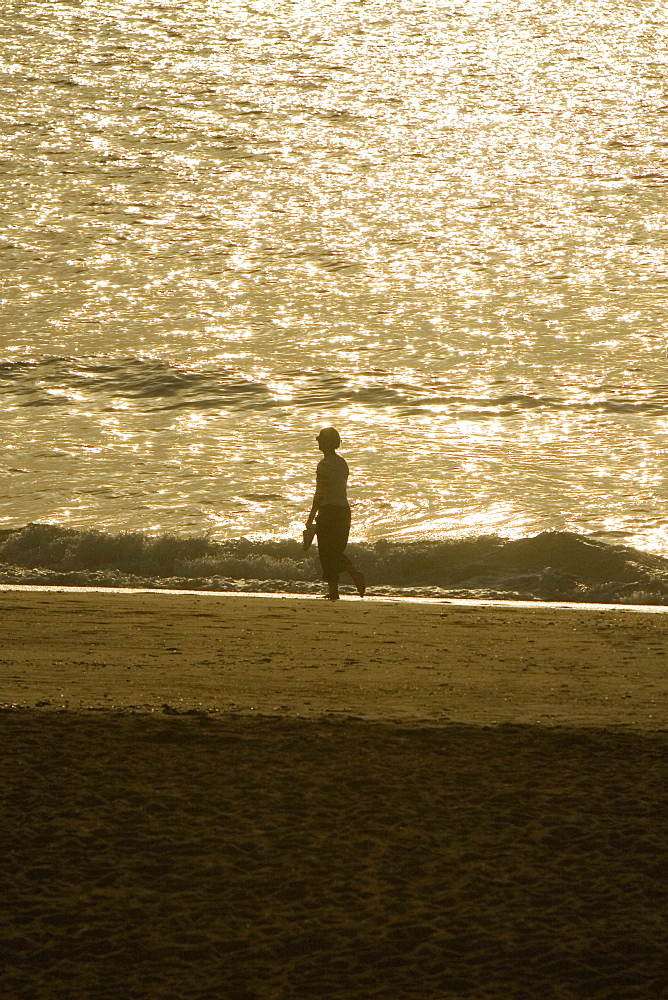 Side profile of a person walking on the beach, Grande Plage, Biarritz, France