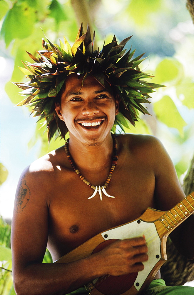 Close-up of a young man playing the ukulele, Hawaii, USA