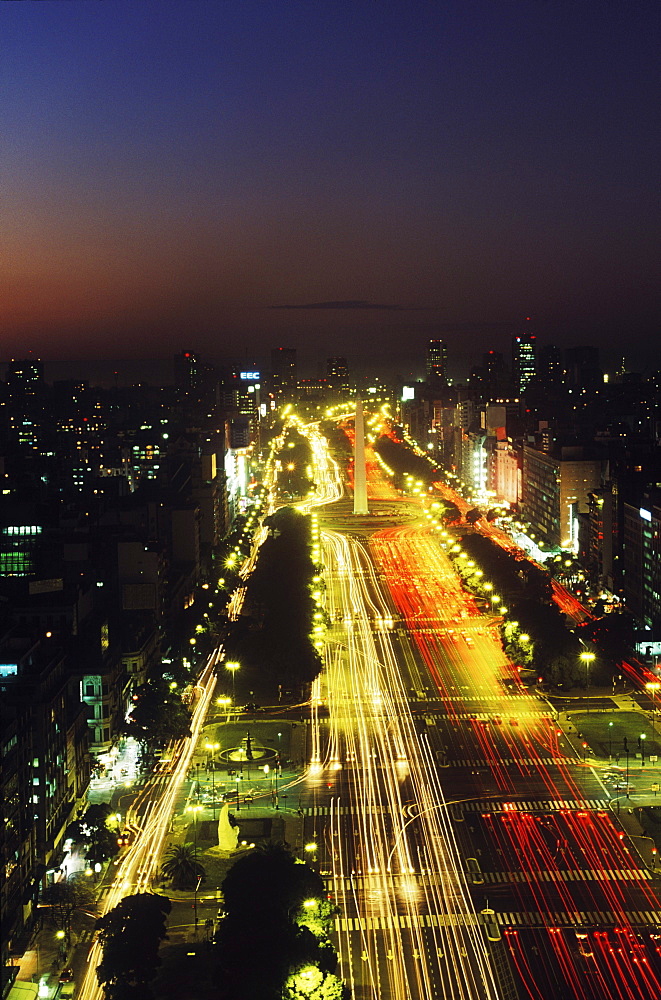 High angle view of buildings in a city lit up at night