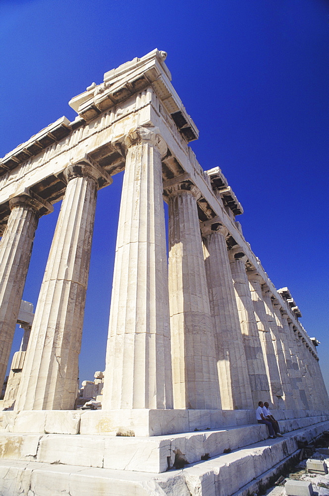 Low angle view of old ruin colonnades in a shrine, Parthenon, Athens, Greece