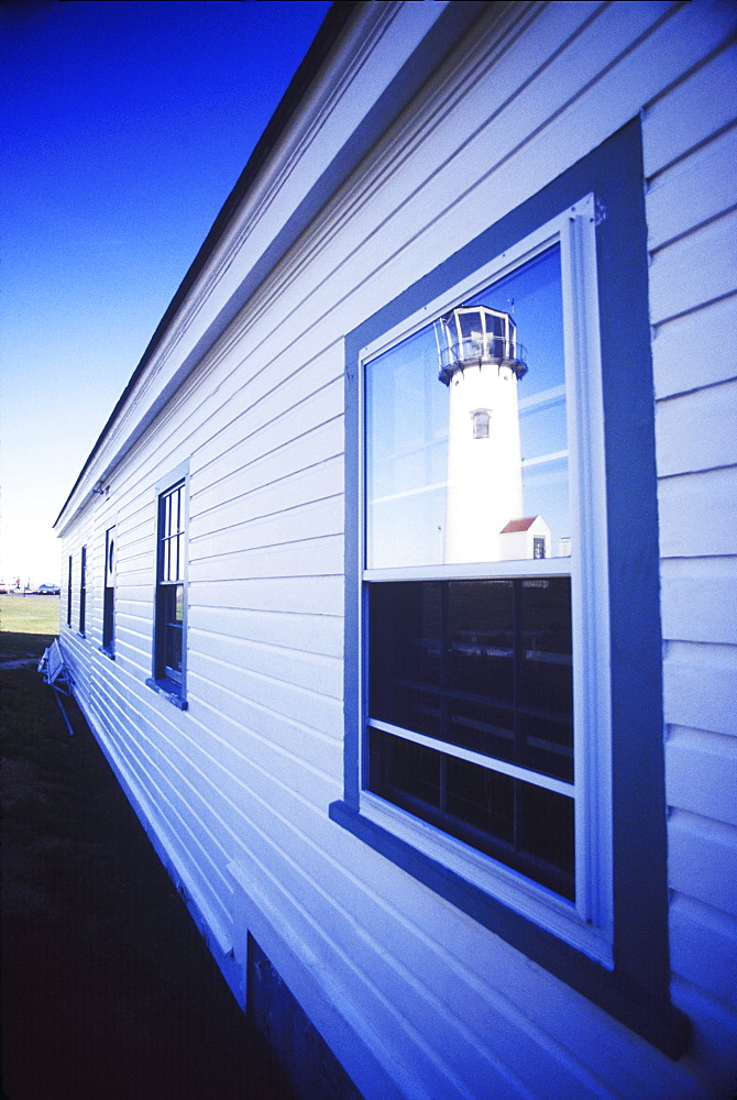 Reflection of a lighthouse in the window of a building, Cape Cod, Massachusetts, USA 